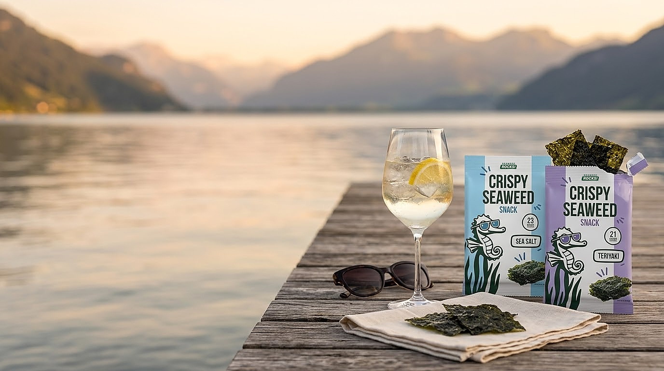 Seaweed Rocks Sea Salt and Teriyaki snacks with a spritz on a jetty by a Swiss lake at sunset